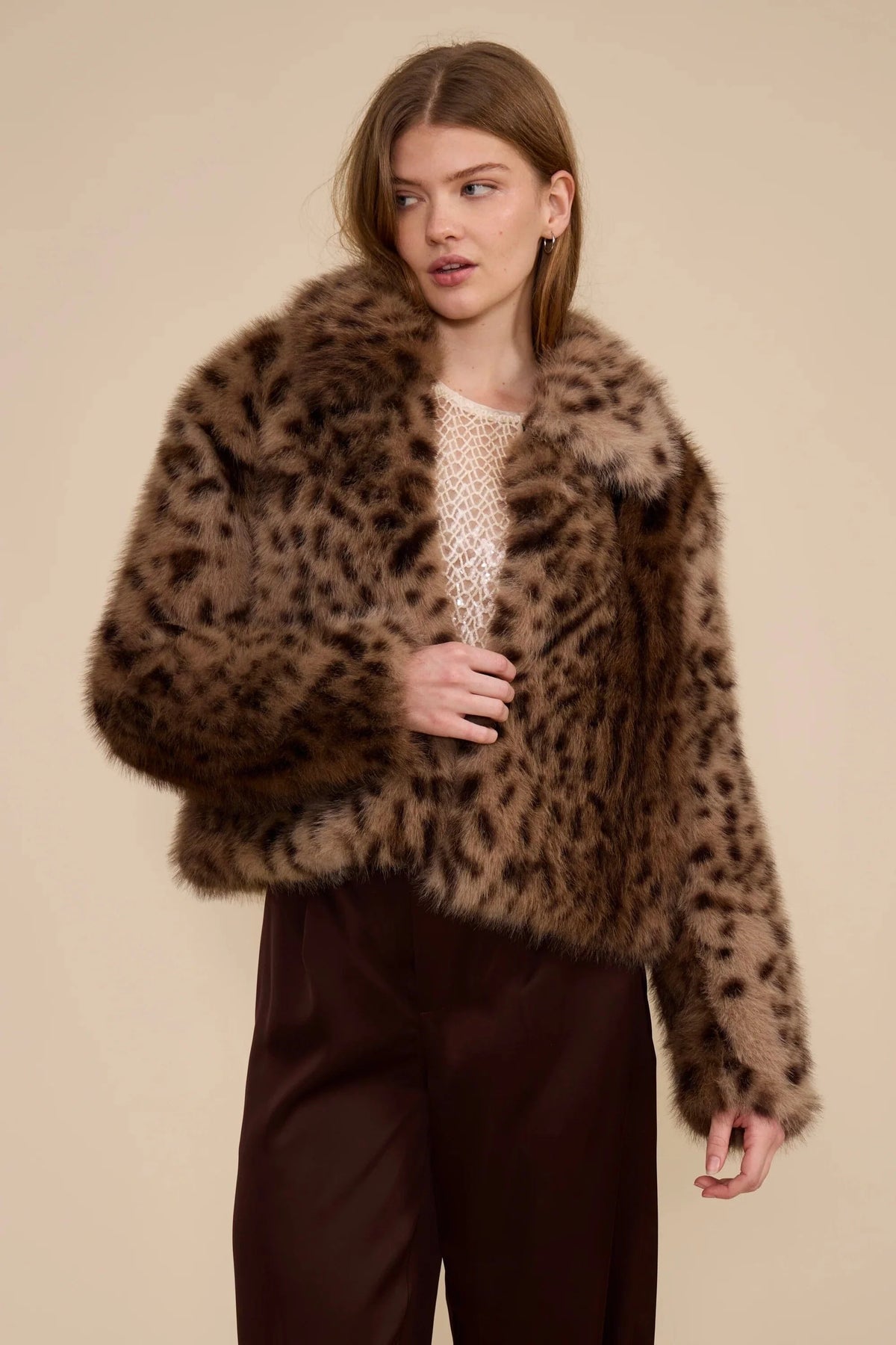 Leopard faux fur jacket with long sleeves and fluffy texture, worn over top