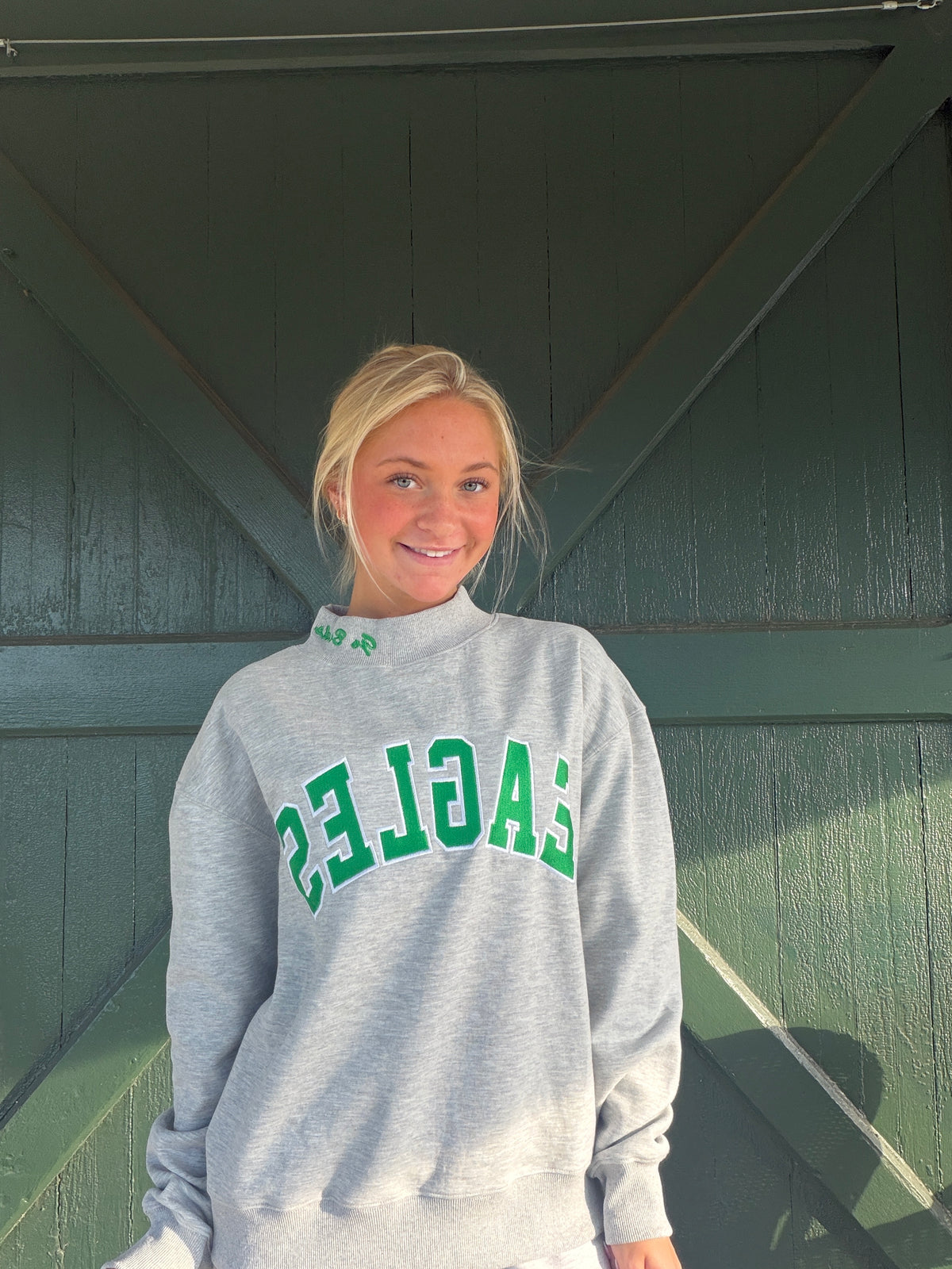 Gray mock-neck sweatshirt with large green 'EAGLES' graphic
