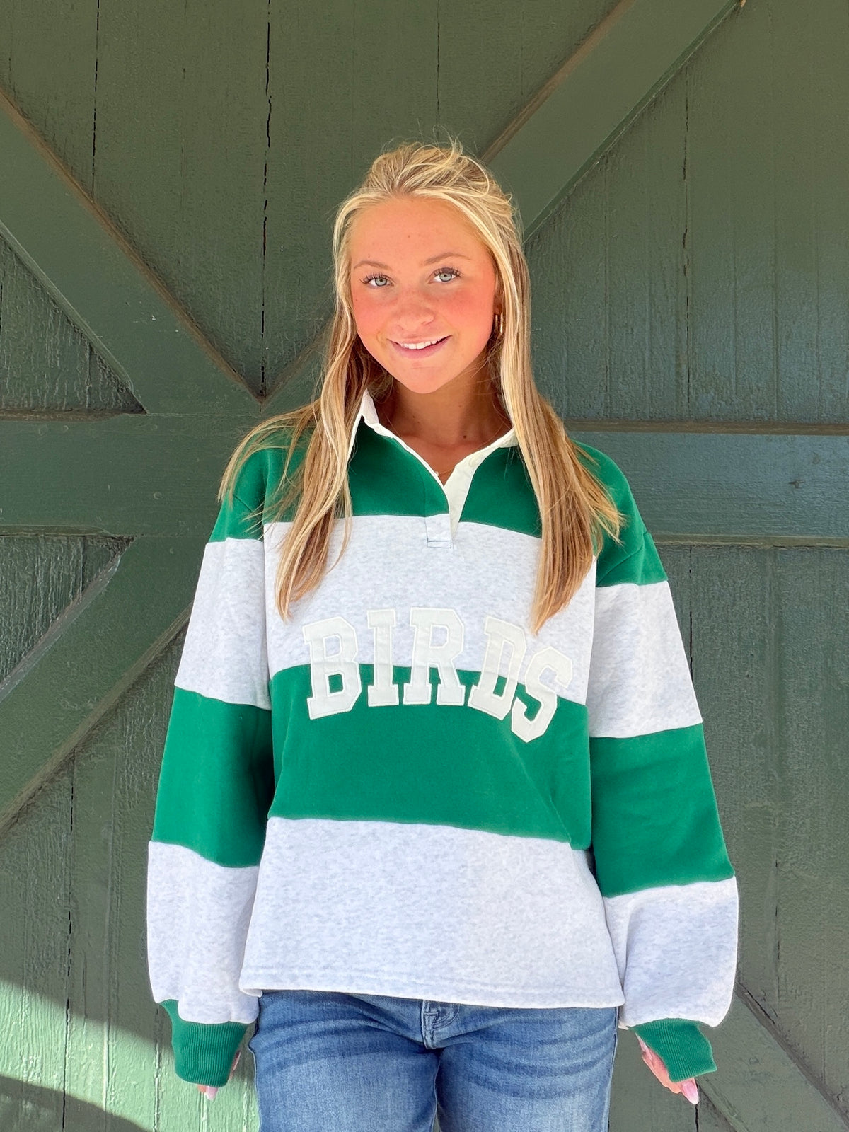 Green and white striped rugby pullover with white collar, Birds wordmark, and cuffs