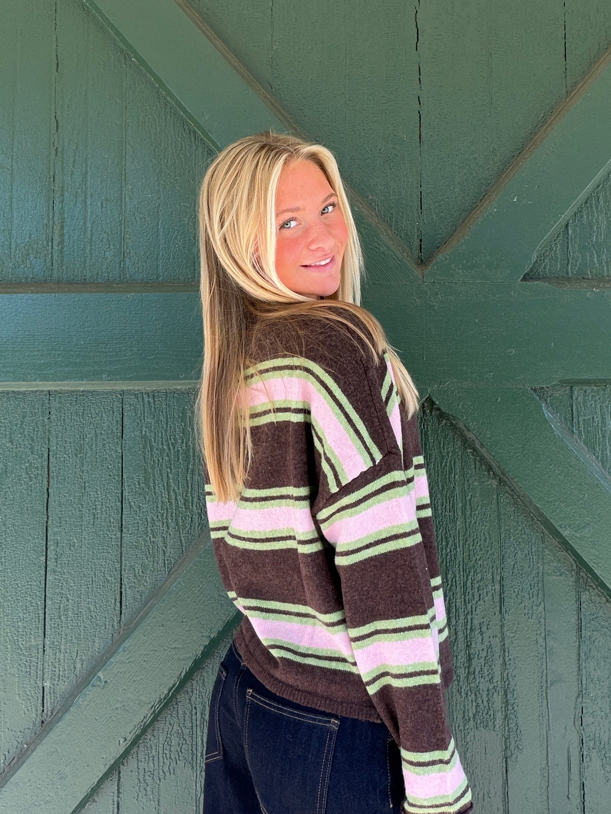Chocolate multicolor varsity stripe cardigan, profile view with button front and ribbed cuffs.