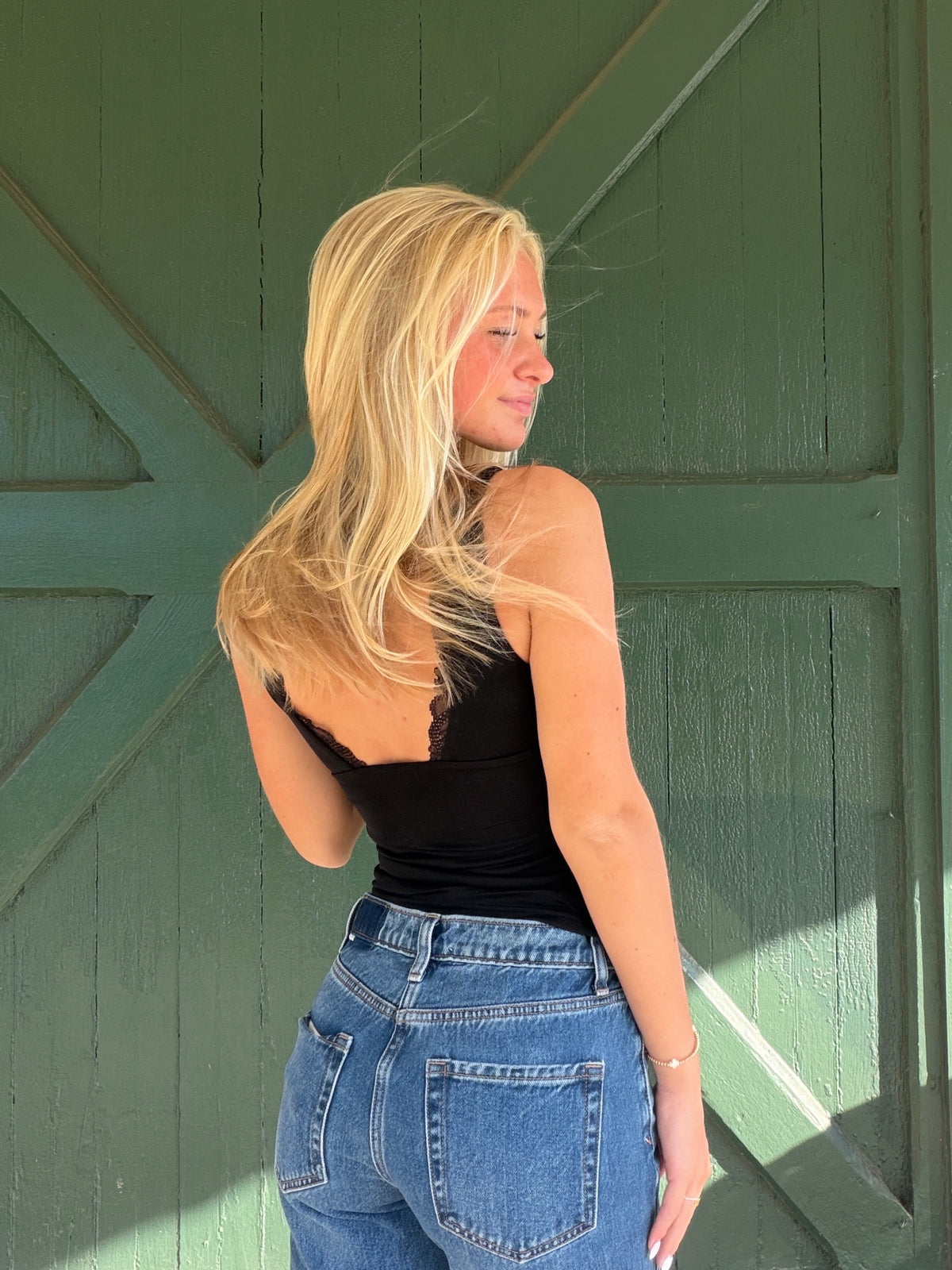 Black ruched tank top with lace-trim scoop back and racerback straps