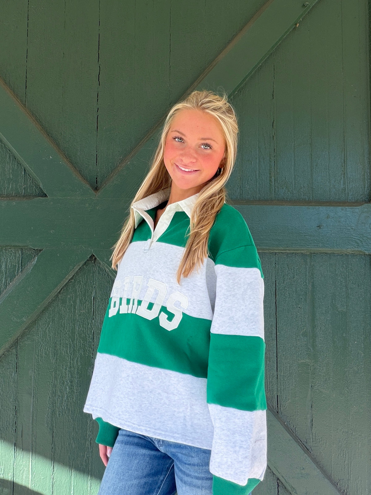 Green and white striped rugby pullover with white collar and Birds team logo
