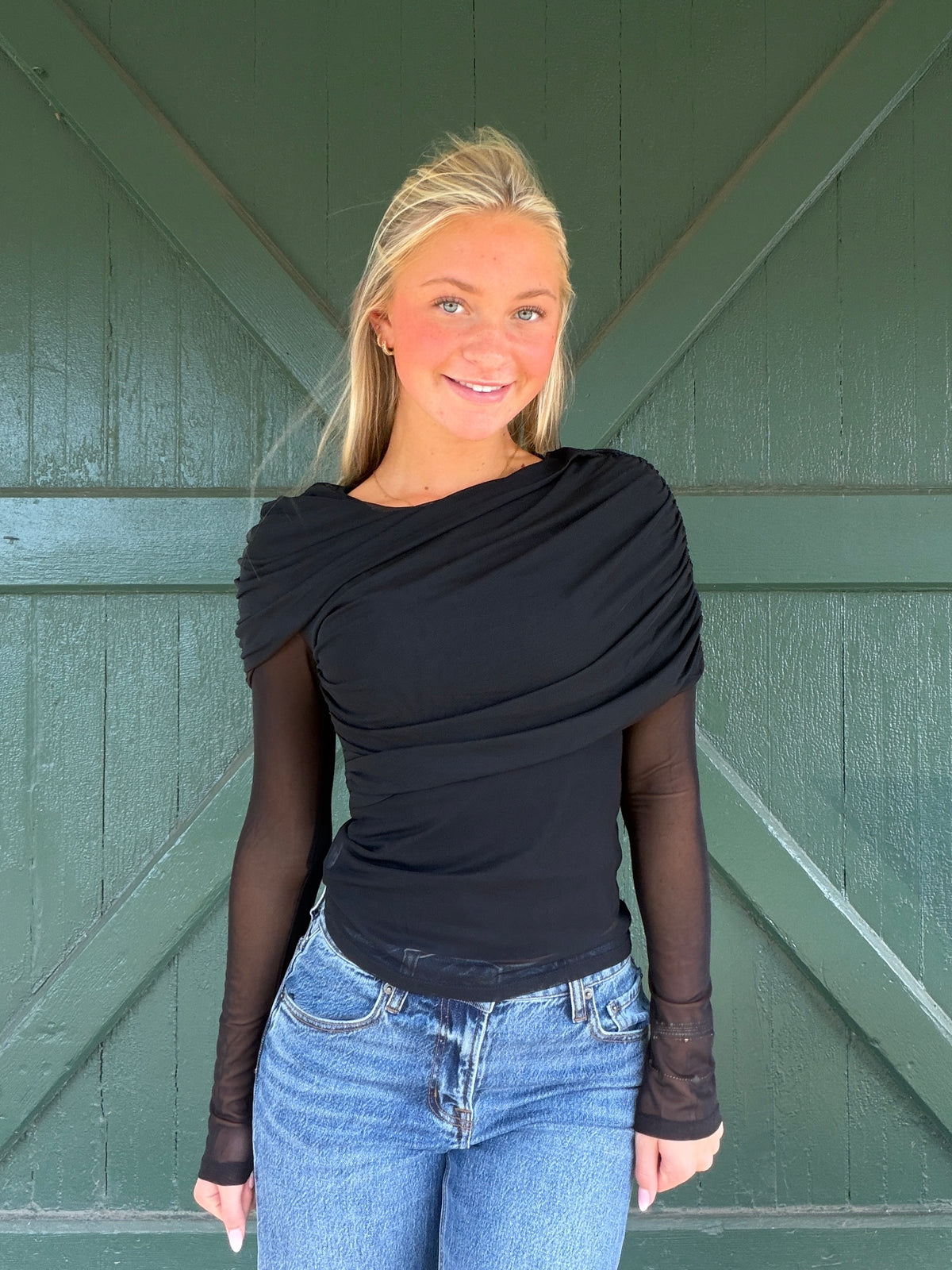 Black long sleeve mesh top with wrapped, ruched front and translucent sleeves
