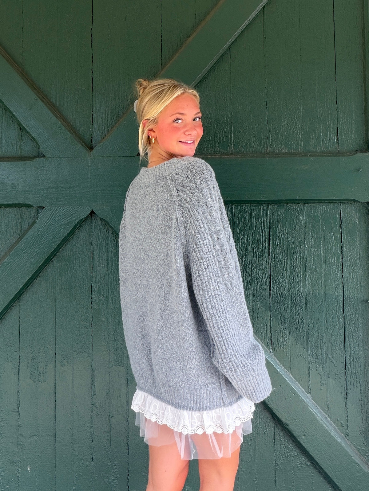 Charcoal knit sweater mini dress with lace-trim hem and long sleeves, back view