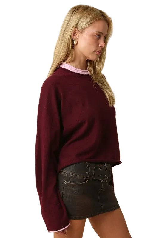 Wine red knit sweater with pink contrast trim at crew neck and sleeve cuffs