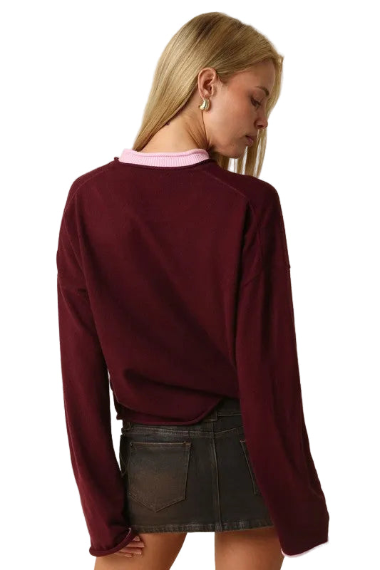Wine red knit sweater with pink contrast crew neck trim and long sleeves