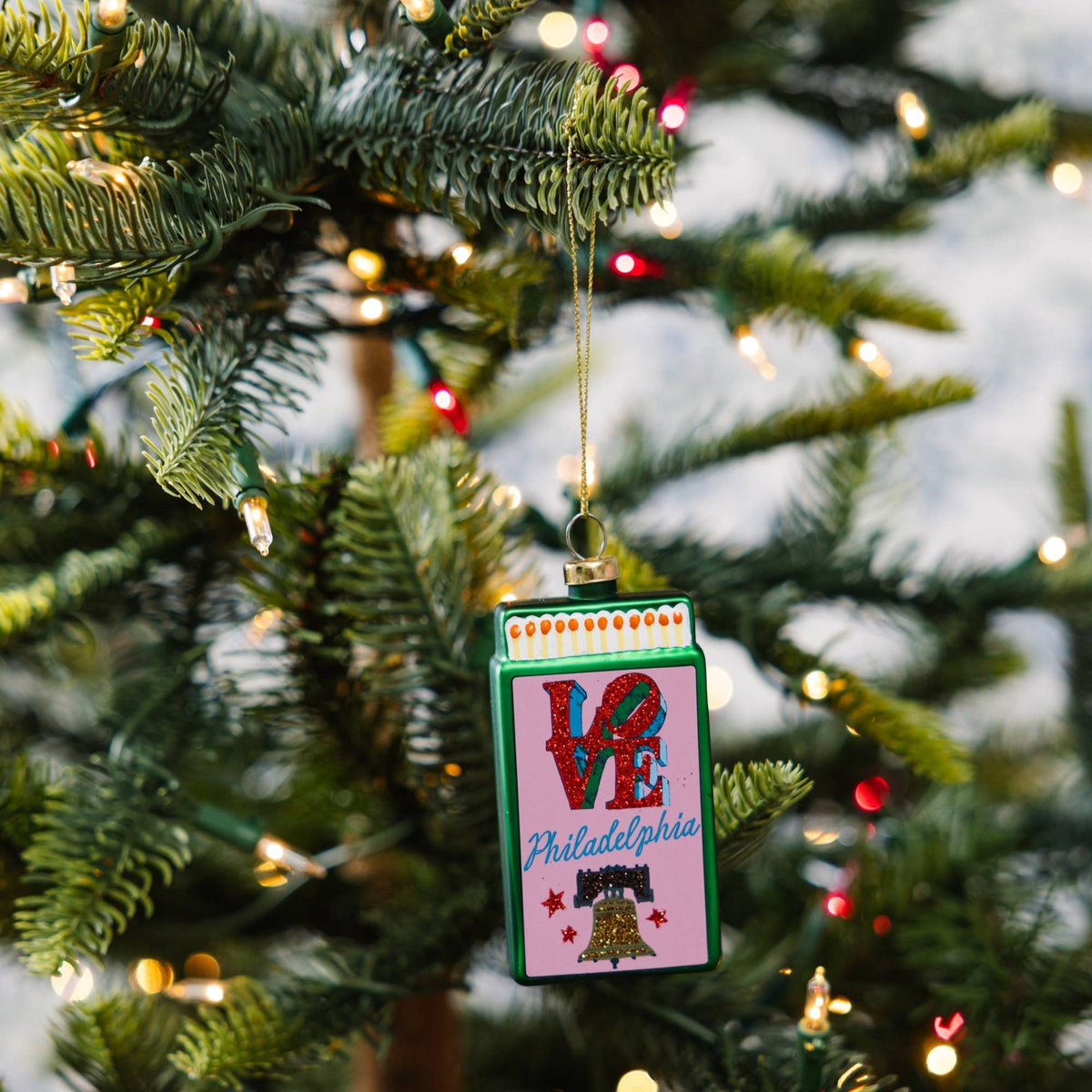 Hanging matchbook ornament on Christmas tree, green border with LOVE and Philadelphia design.