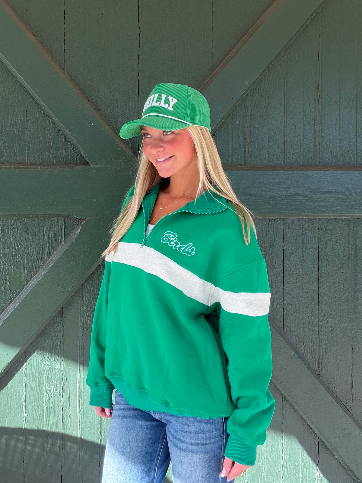 Green quarter-zip sweatshirt with white chest stripe and Eagles script logo