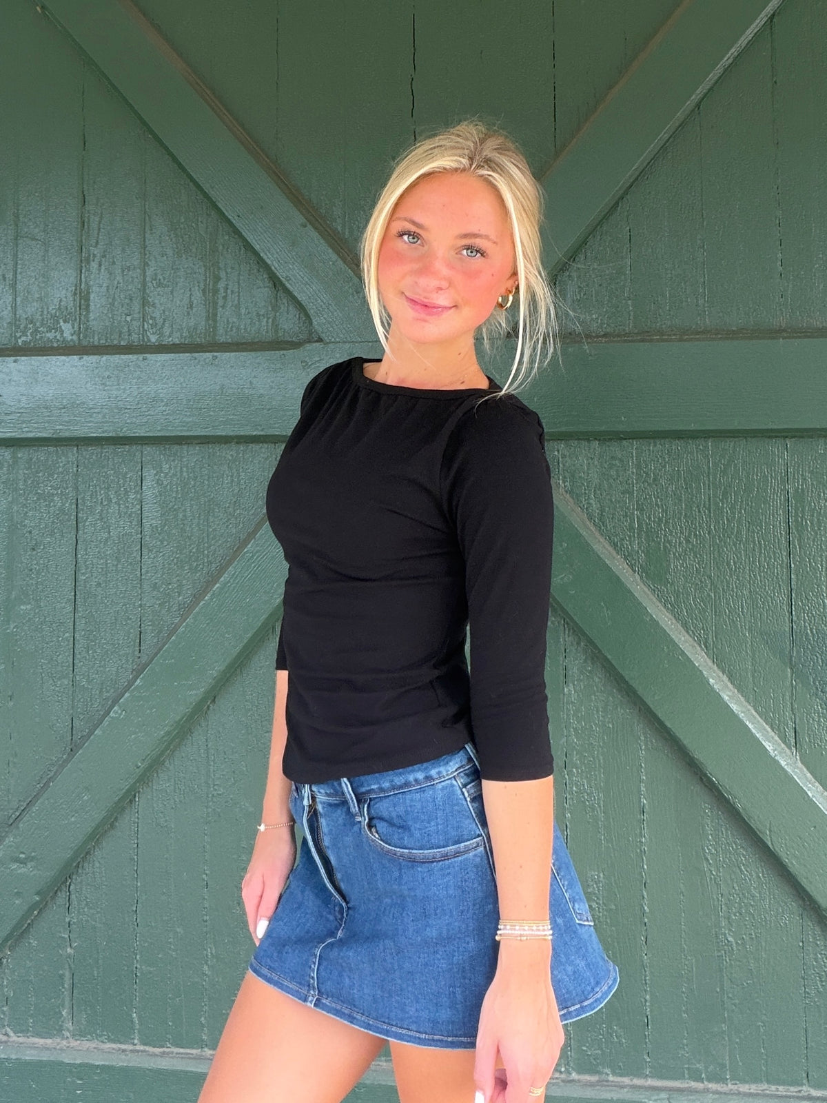 Black boat-neck three-quarter sleeve top with ruched waist detail