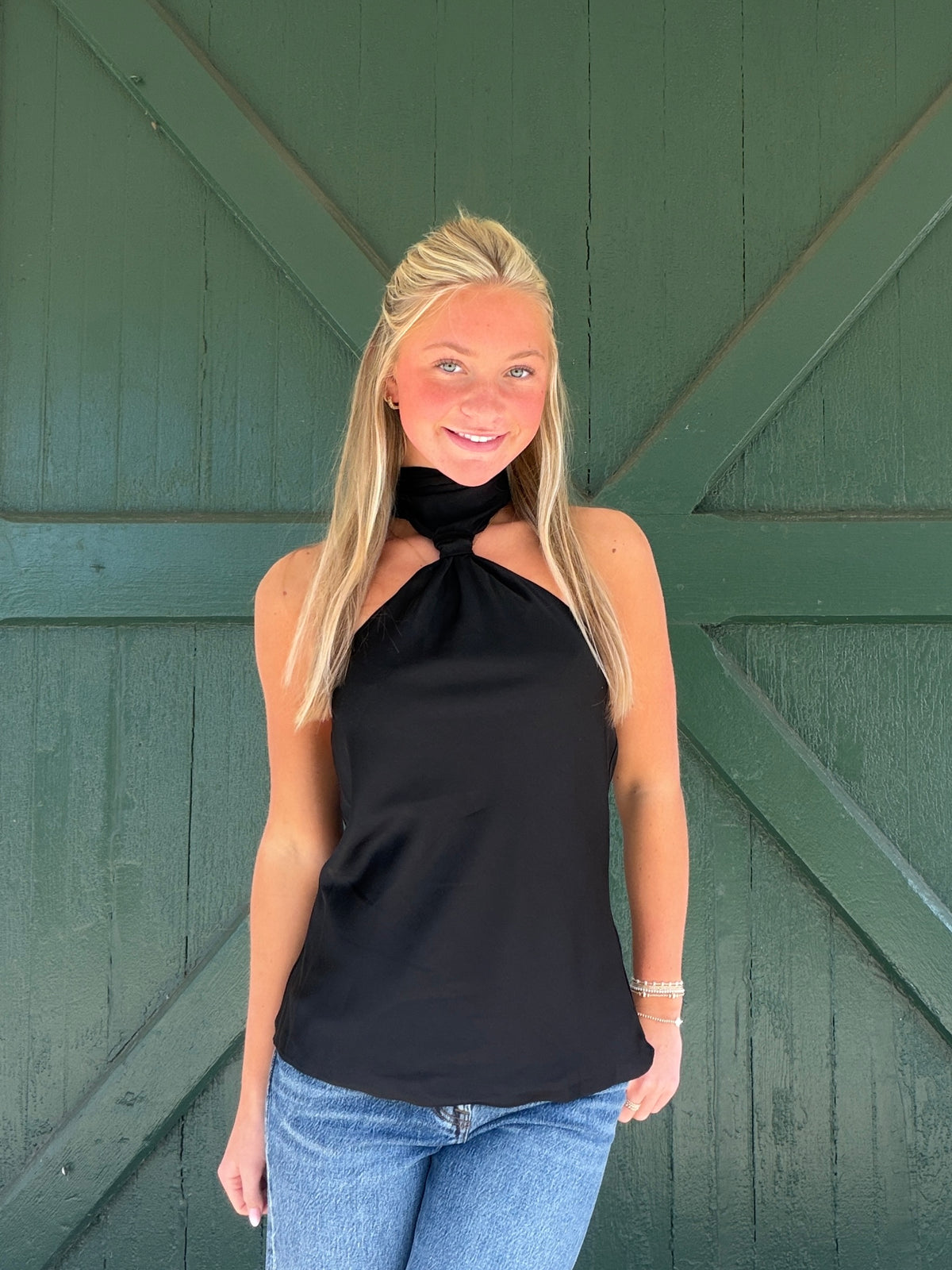 Black halter top with twisted front knot and sleeveless fit