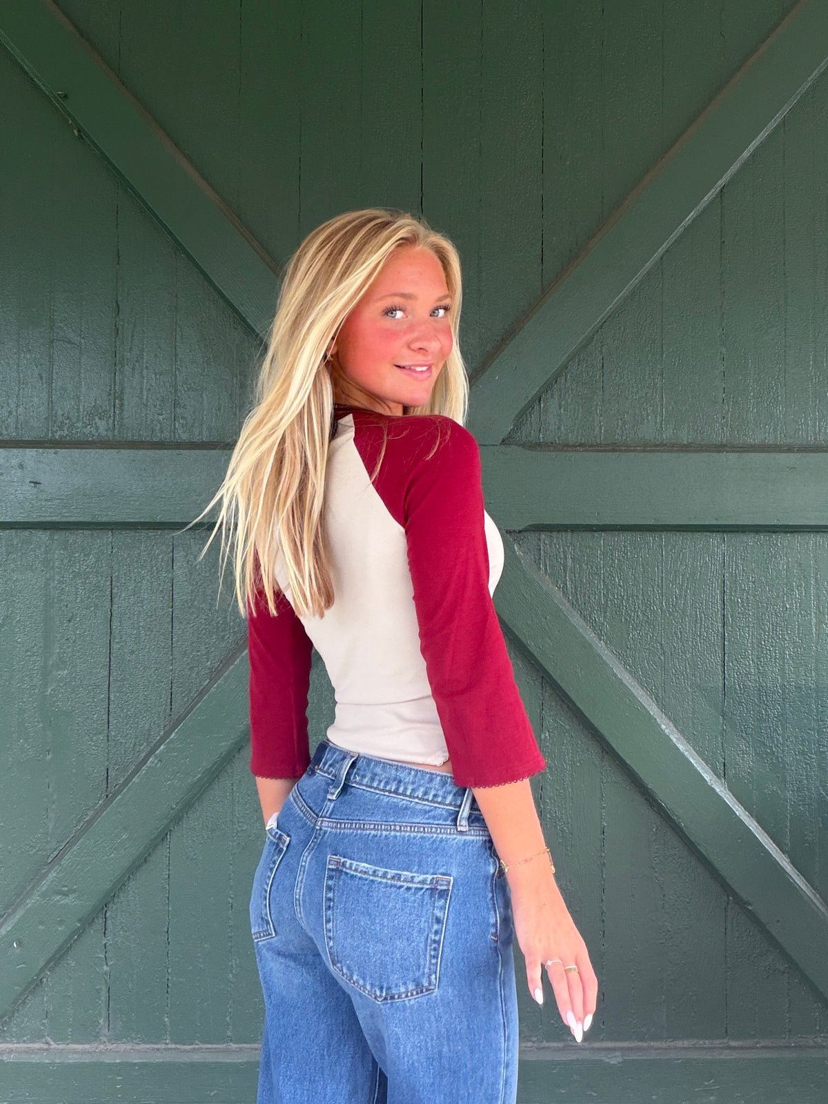 Baseball tee with taupe body and burgundy 3/4 sleeves, side view