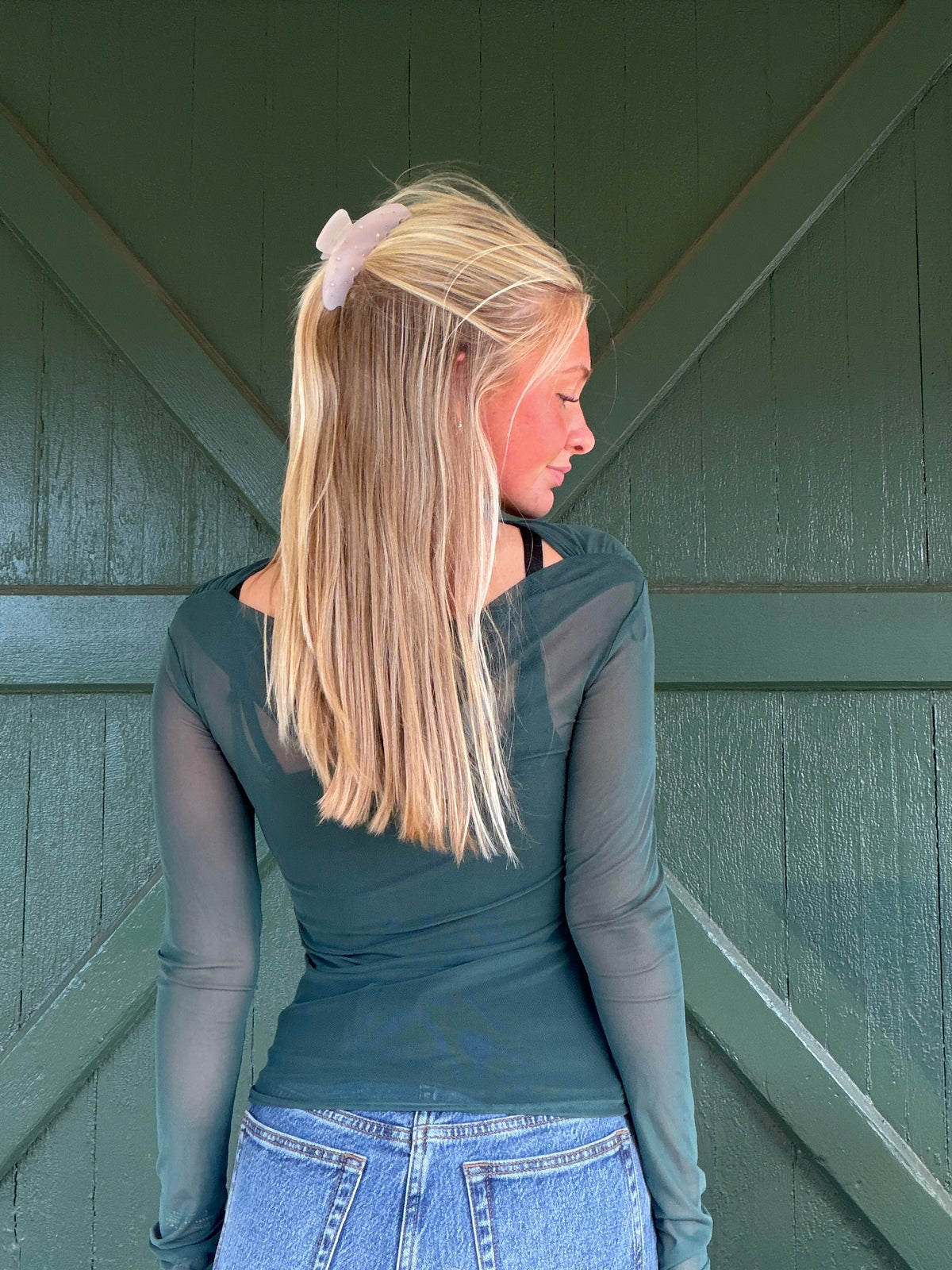 Hunter green mesh long-sleeve top, fitted crew neck, side/back view