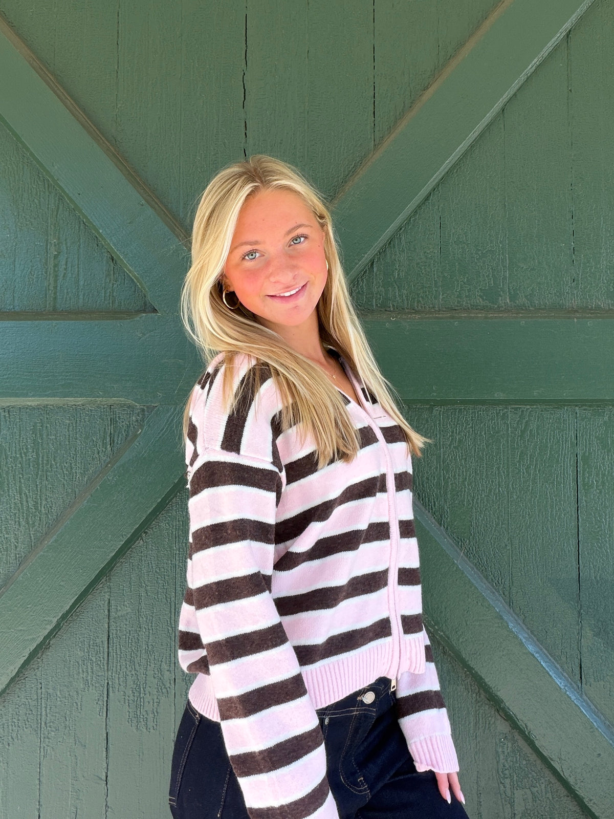Pink and white striped zip-front sweater hoodie with hood and ribbed hem