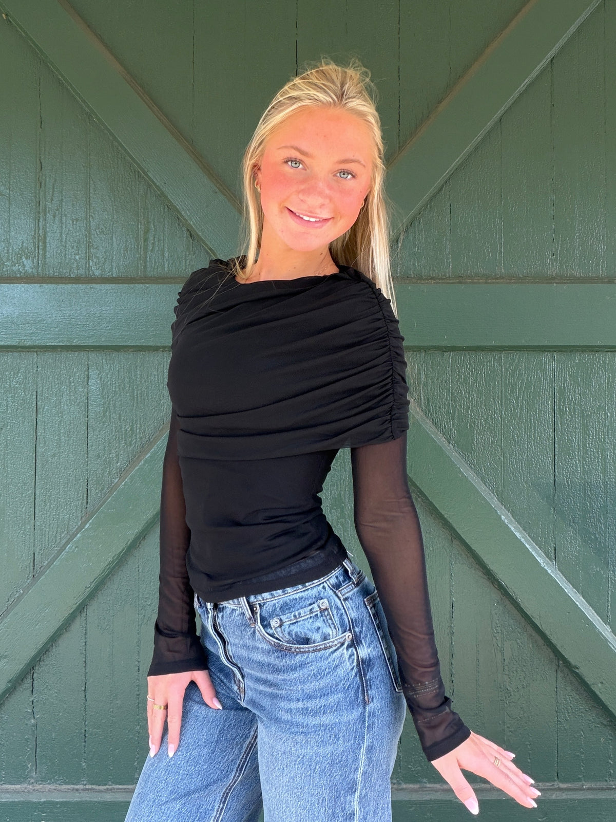 Black long sleeve mesh top with gathered, draped neckline and sheer sleeves