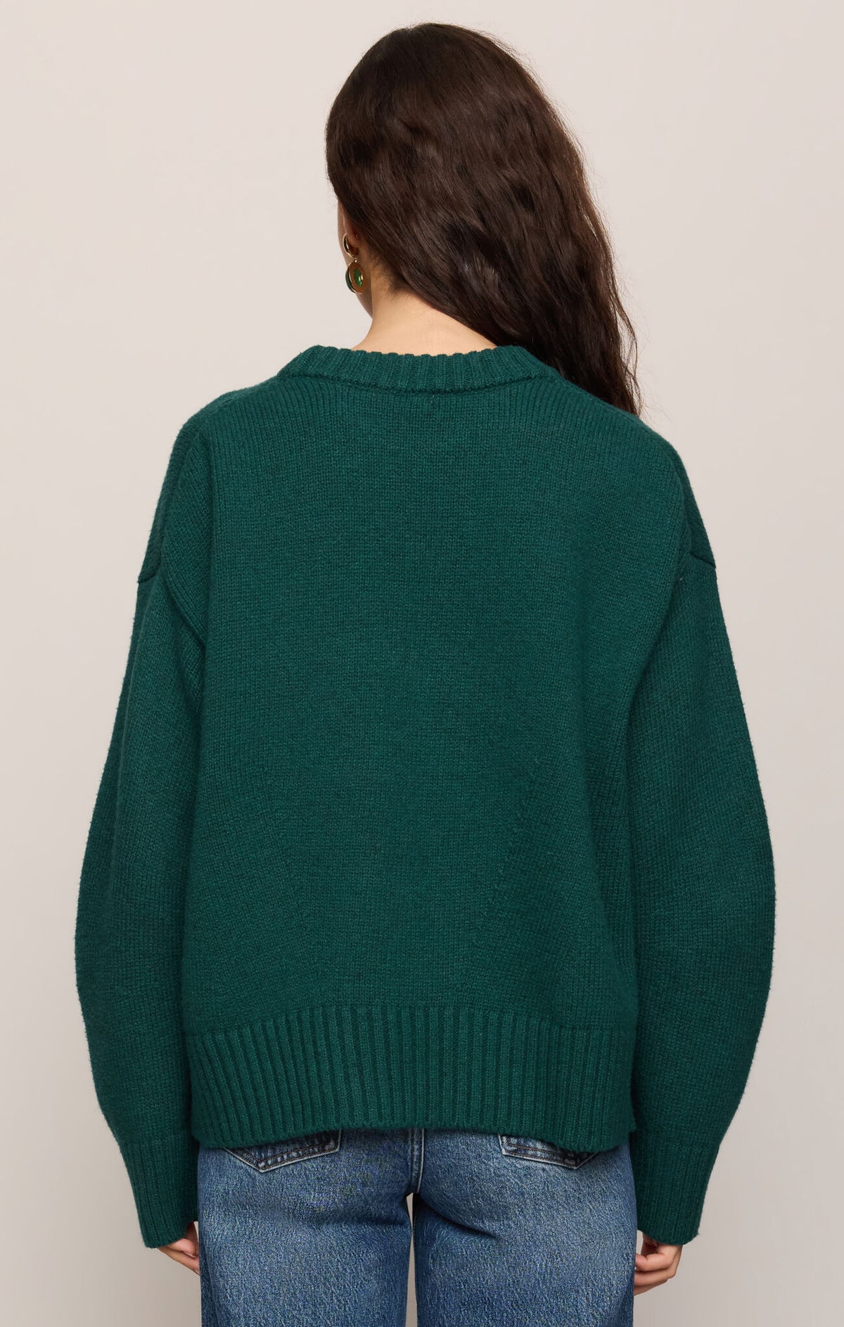 Dark green crew neck knit sweater with ribbed hem and cuffs, back view