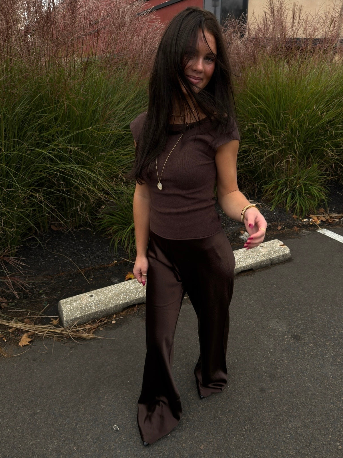 Brown satin bias pants with flared cuffs and fitted legs