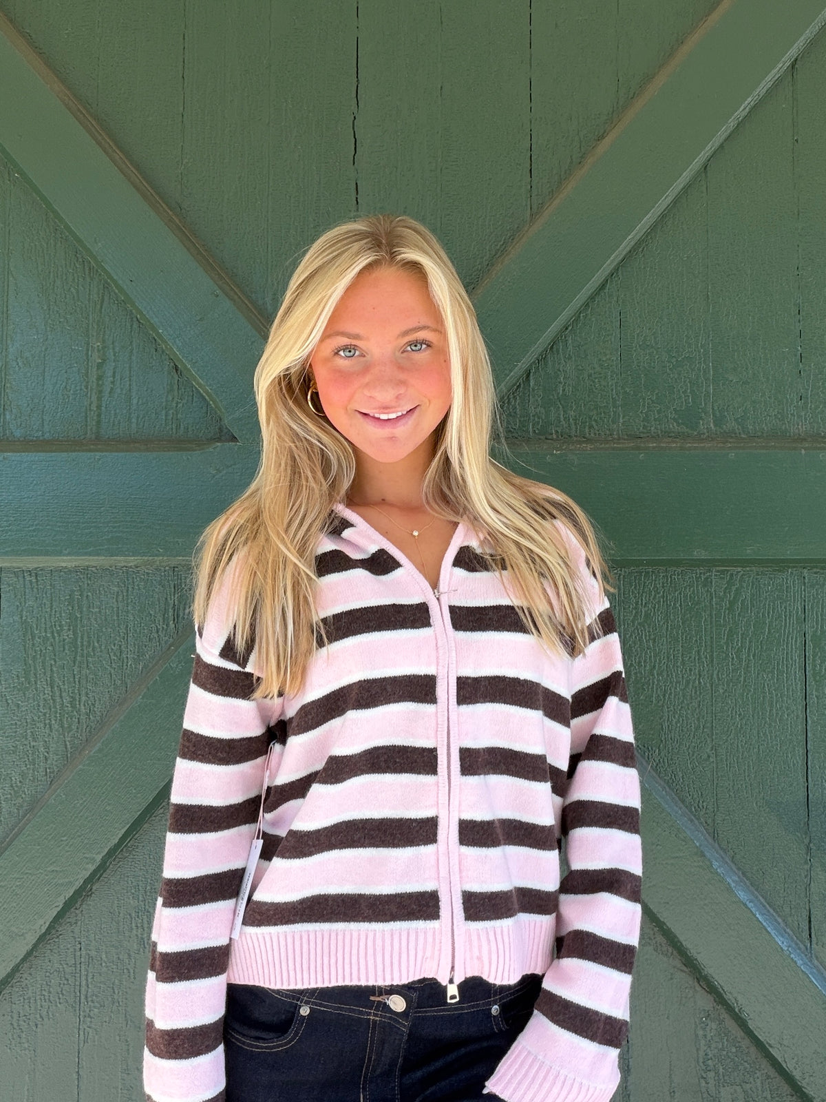 Pink and white striped zip-front sweater hoodie with hood and ribbed cuffs