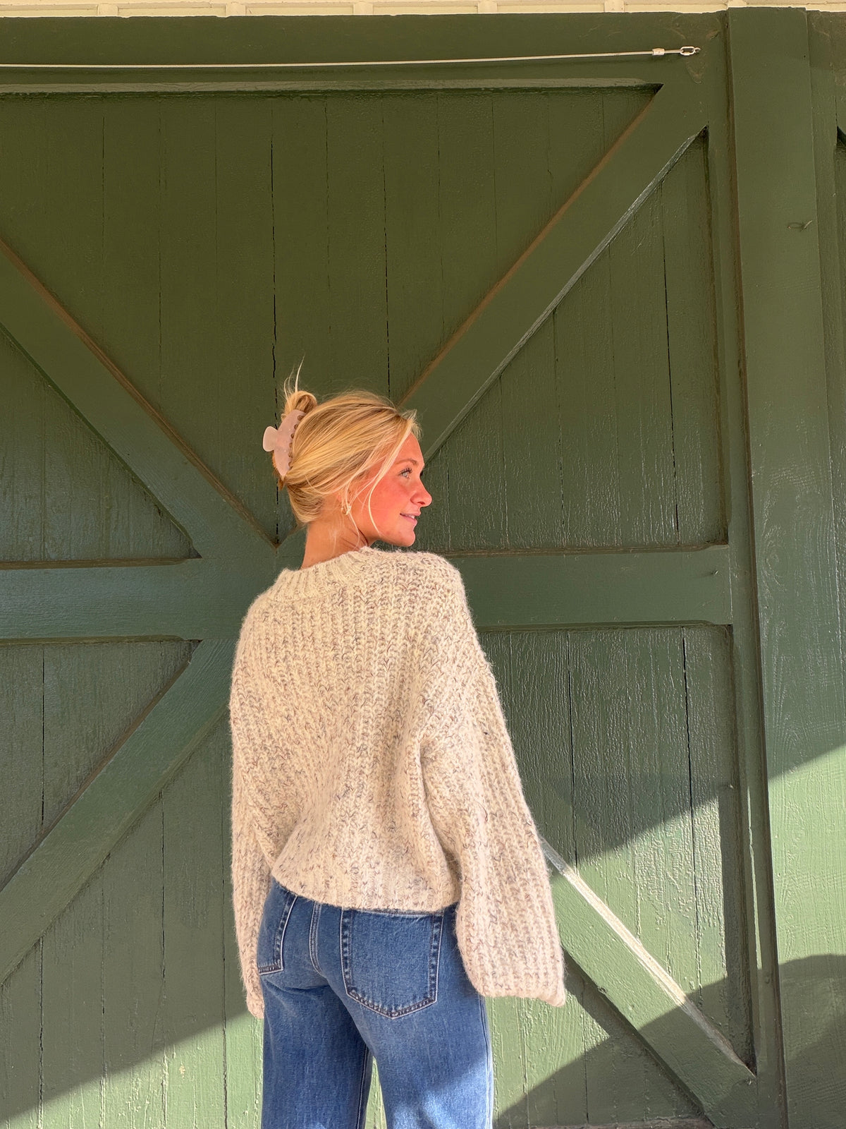Ecru textured knit pullover sweater with long sleeves and crew neck