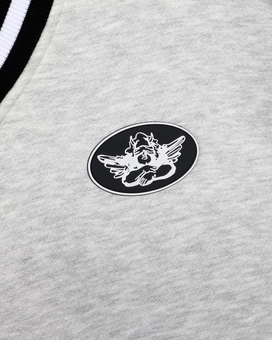 Grey sweatshirt chest patch logo with black-and-white winged emblem