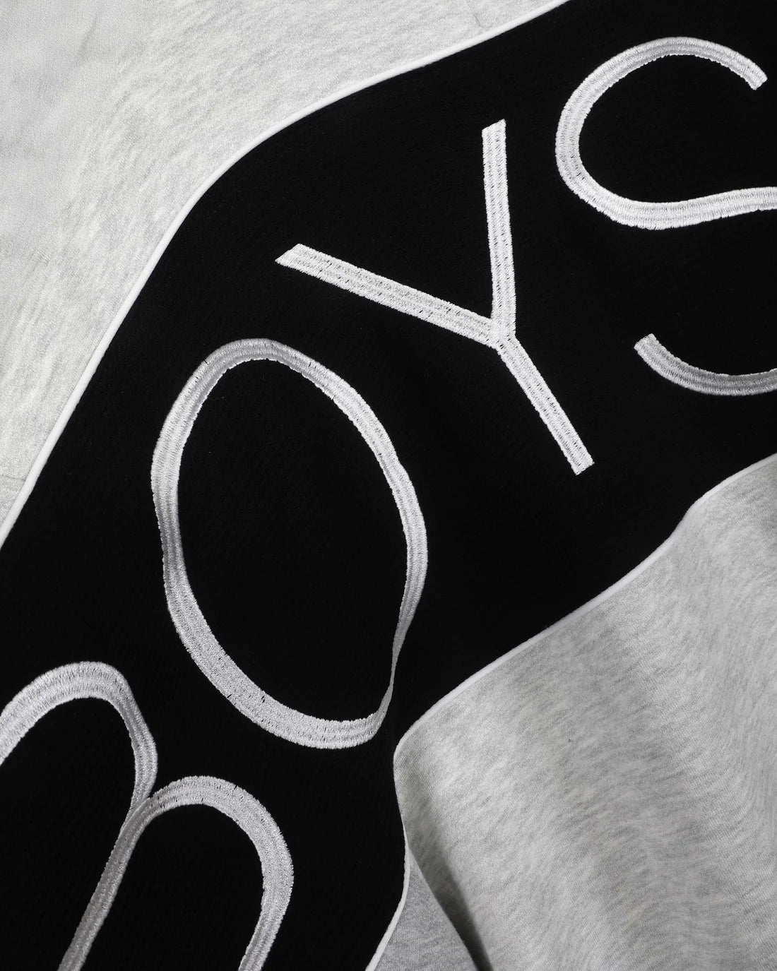Black sleeve panel with light lettering on heather grey boys sweatshirt