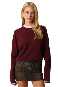 Wine red knit sweater with pink contrast crew neckline and long sleeves