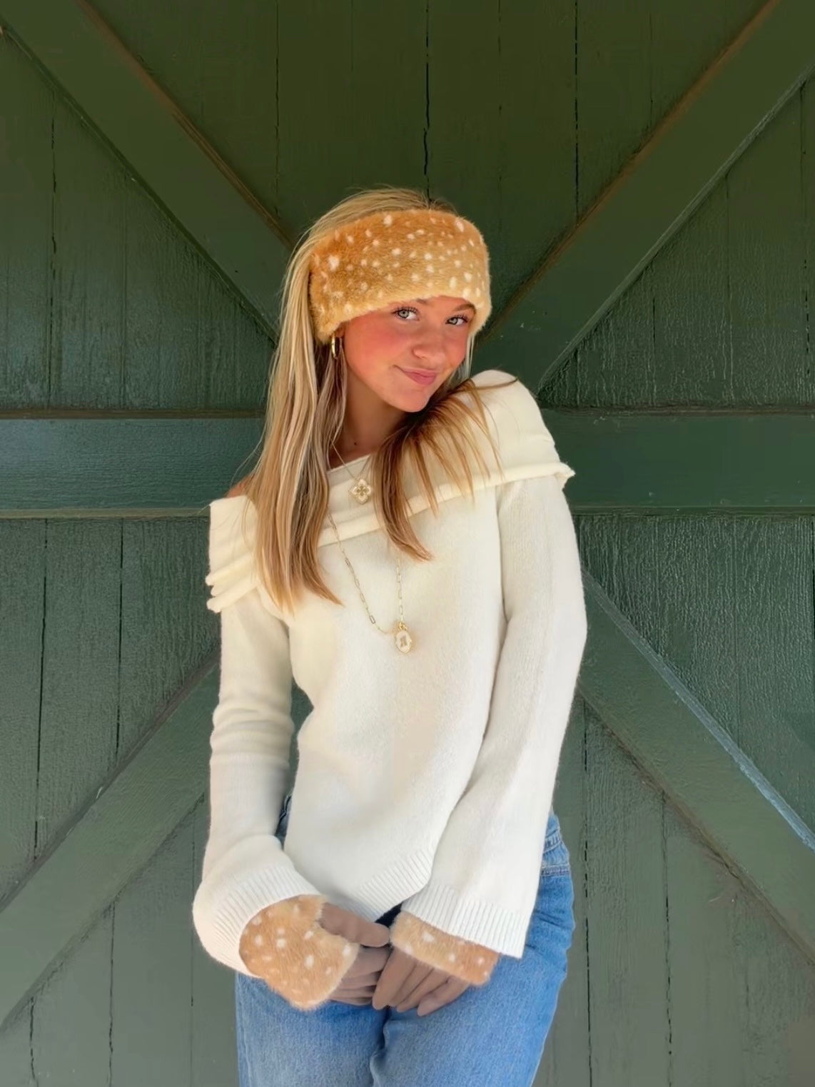 Front view of the ivory Audrey off-the-shoulder sweater with a folded neckline and flared ribbed cuffs.