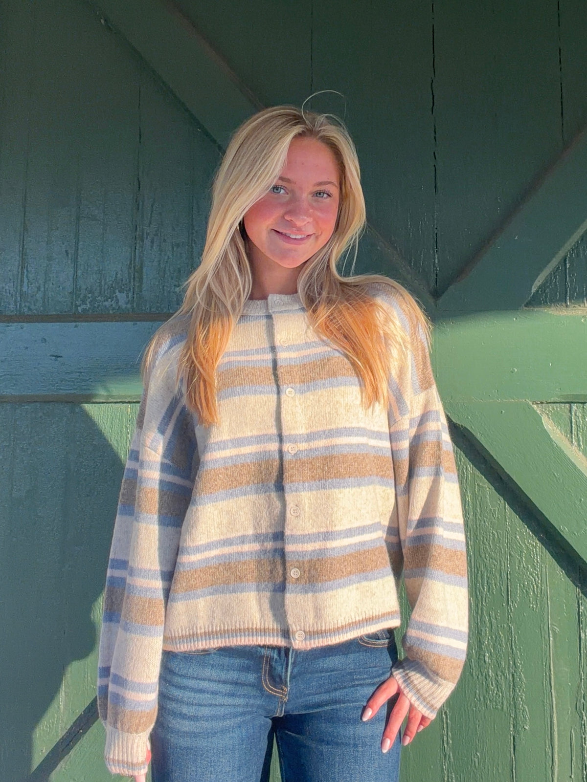 Striped crew neck cardigan with a button front, long sleeves, and ribbed cuffs and hem