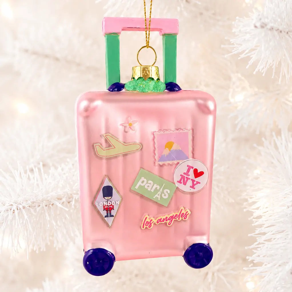 Pink suitcase-shaped travel luggage ornament with gold hanger and travel stickers