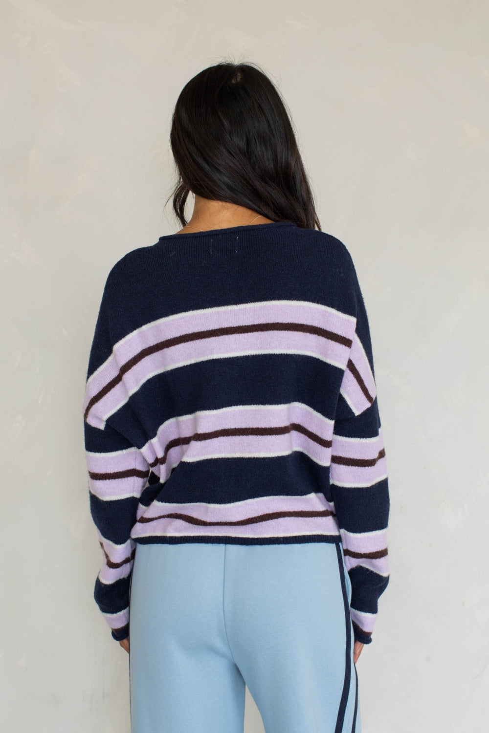 Navy striped varsity cardigan, back view, with wide lavender horizontal bands and button placket