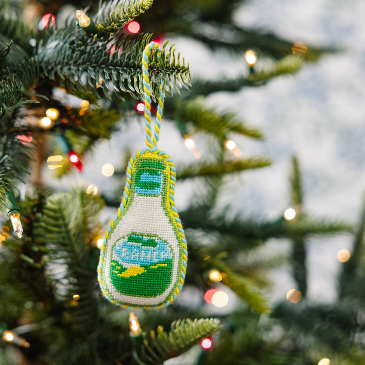 Needlepoint ranch dressing bottle ornament with green-and-blue design, hanging loop