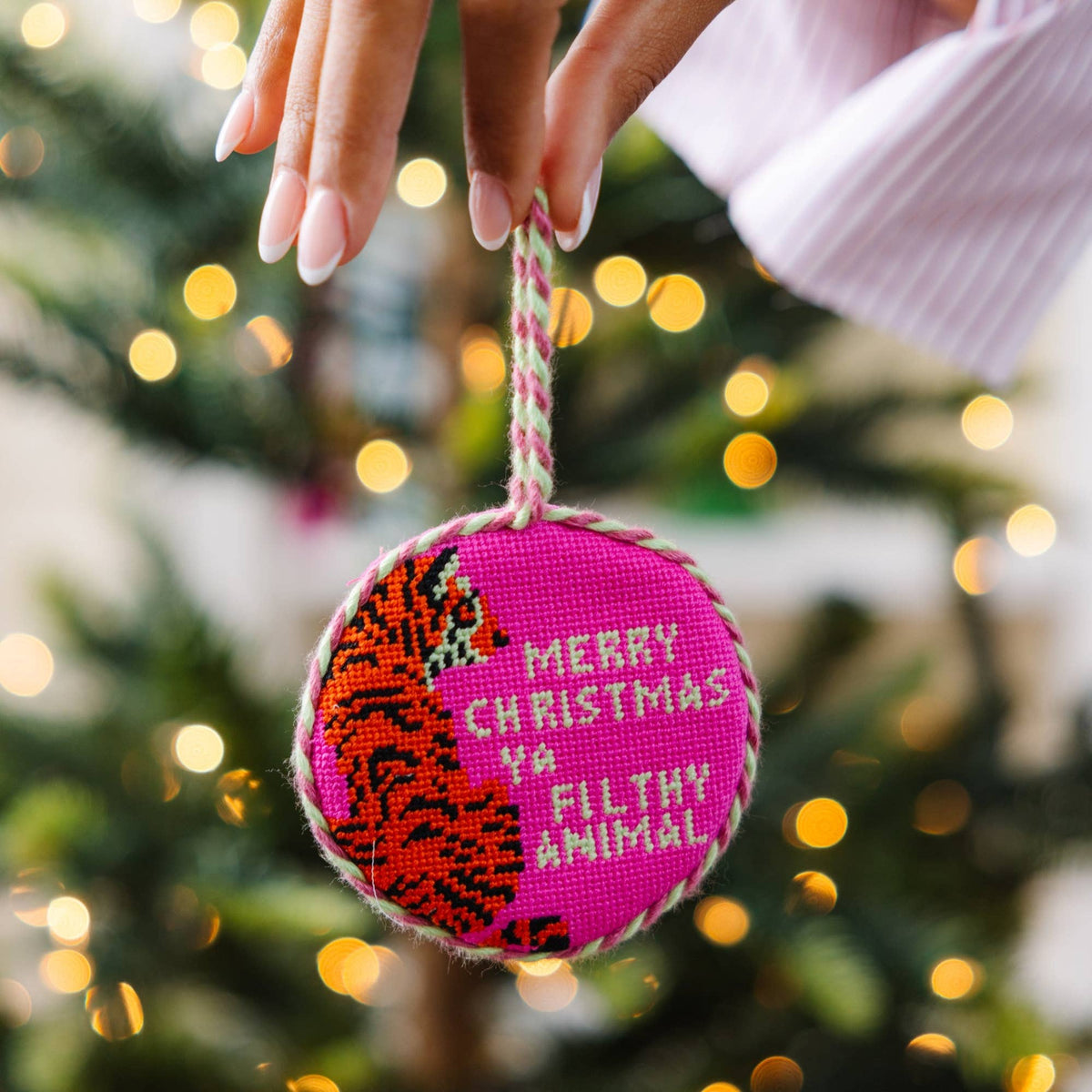 Furbish Studio needlepoint Christmas ornament ball, pink with stitched “MERRY CHRISTMAS FILTHY ANIMAL”